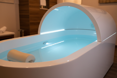 Float tank interior with salt water and blue LED lighting