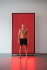 Full-body red light therapy panel wider and taller than standing person